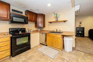 ADU Kitchen with black appliances, a sink, open shelves, light countertops, and recessed lighting