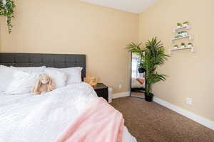 Carpeted bedroom with baseboards
