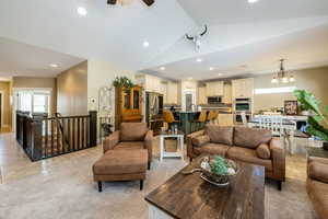 Living area with recessed lighting, lofted ceiling, a ceiling fan, and light tile patterned flooring