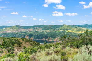 View of mountain backdrop featuring a nearby body of water