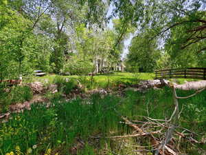 View of yard featuring fence