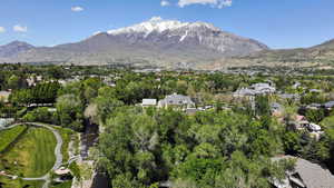Aerial view of property's location with a mountainous background and nearby suburban area
