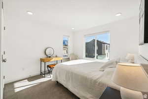Bedroom with carpet flooring, baseboards, and recessed lighting