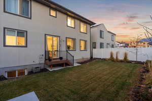 Back of property at dusk with stucco siding