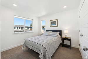 Carpeted bedroom with baseboards and recessed lighting