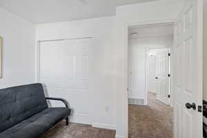 Sitting room with carpet flooring and baseboards