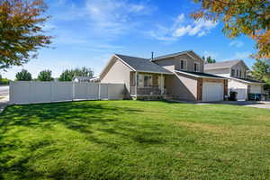 Split level home featuring a porch and driveway