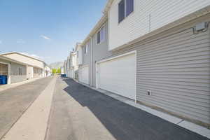 View of side of property featuring a residential view and a garage