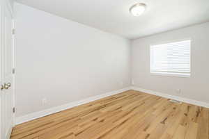 Empty room featuring wood finished floors and baseboards