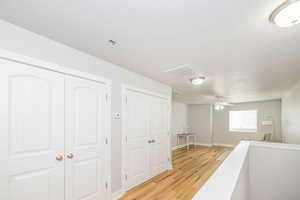 Hall with light wood-style flooring and baseboards