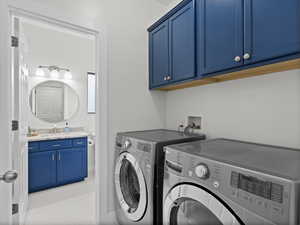 Fully remodeled laundry with custom cabinetry and remodeled half bathroom in background