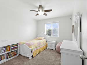 Bedroom with light colored carpet and a ceiling fan