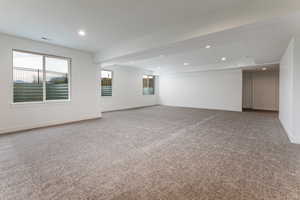 Carpeted empty room featuring recessed lighting and baseboards