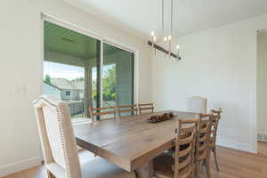 Dining room featuring light wood-style floors and a chandelier