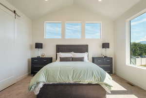 Bedroom with a barn door, carpet floors, lofted ceiling, and recessed lighting