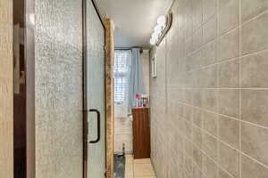 Hall with tile walls and tile patterned floors