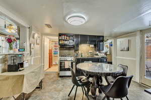 Dining room with light stone finish floors