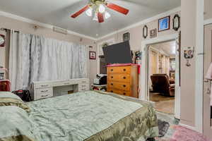 Bedroom with ornamental molding and ceiling fan