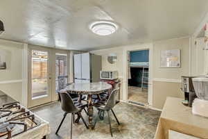 Dining area featuring stone finish flooring and baseboards