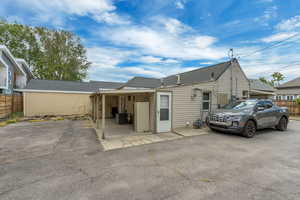 Rear view of property featuring fence and a patio