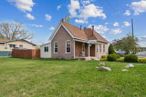 Back of property with a chimney and brick siding