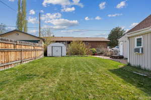 View of yard with a storage unit and an outdoor structure