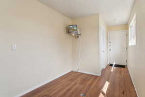 Hallway featuring wood finished floors and baseboards