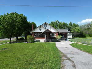 View of front of home featuring concrete driveway and brick siding