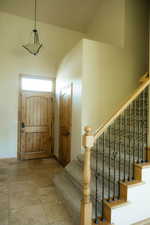 This welcoming entry with its transom window helps let in the light.
