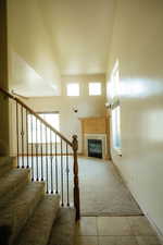 The majestic stairway is enhanced by the soaring ceiling and open great room