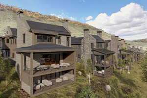 Rear view of property with stone siding, a chimney, a standing seam roof, and a mountain view