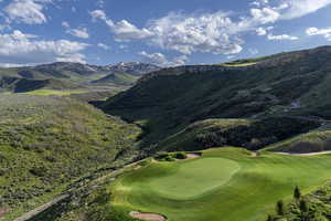 View of mountain background featuring a local golf course