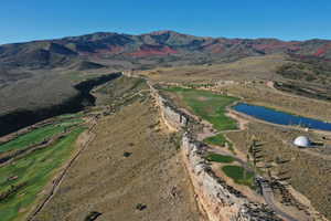 Aerial overview of property's location featuring a water and mountain view and a golf course
