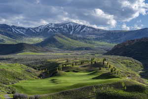 View of mountain background featuring a local golf course