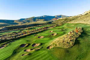 View of mountain background featuring a local golf course