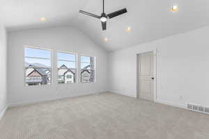 Spare room featuring lofted ceiling, a ceiling fan, light carpet, baseboards, and recessed lighting