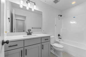 Full bath with toilet, vanity, shower / tub combination, and tile patterned flooring