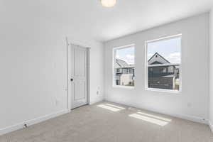 Carpeted spare room with baseboards and a textured ceiling