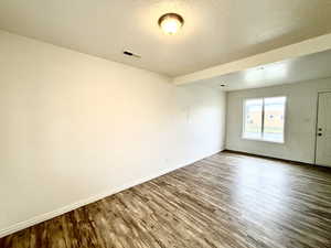 Empty room with wood finished floors and baseboards