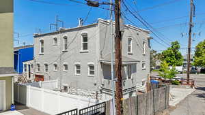View of front of house featuring fence and brick siding
