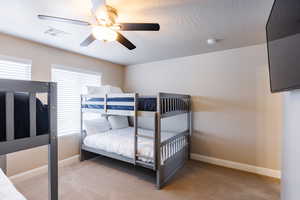 Bedroom featuring carpet flooring, baseboards, and a ceiling fan