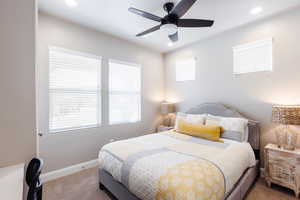 Bedroom featuring light carpet, recessed lighting, baseboards, and a ceiling fan