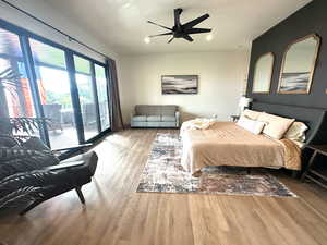Bedroom featuring access to outside, wood finished floors, recessed lighting, and ceiling fan
