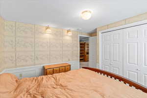 Bedroom with a closet and a textured ceiling