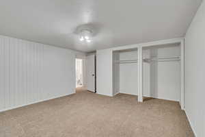 Unfurnished bedroom with multiple closets, carpet flooring, and baseboards