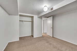 Unfurnished bedroom with carpet, baseboards, and a closet