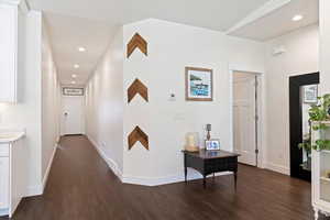 Hall with dark wood-style floors, baseboards, and recessed lighting