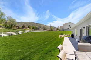 View of yard featuring a mountain view and a patio