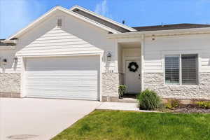 Single story home with concrete driveway, a garage, and roof with shingles