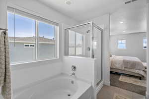 Primary suite full-bathroom featuring a stall shower, a bath, connected bathroom, tile floors, and recessed lighting